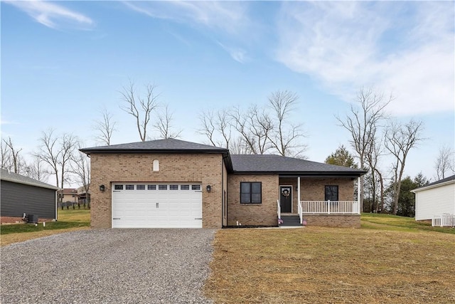 view of front of home with a garage, covered porch, and a front yard