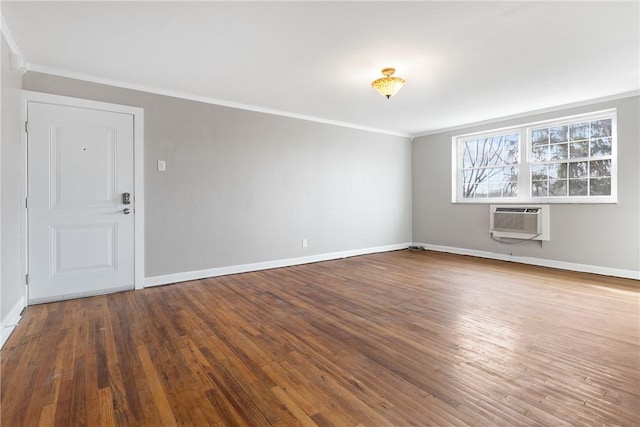 spare room featuring ornamental molding, an AC wall unit, and hardwood / wood-style floors