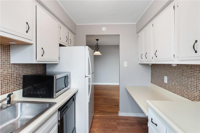 kitchen with pendant lighting, sink, dishwasher, white cabinetry, and dark hardwood / wood-style flooring