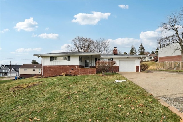 view of front of property with a garage and a front lawn