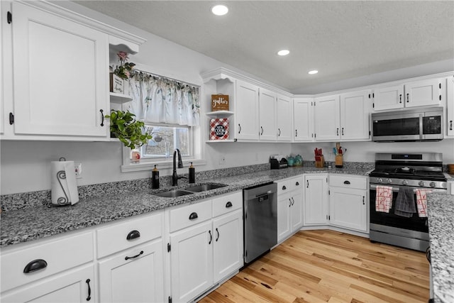 kitchen featuring white cabinetry, sink, and appliances with stainless steel finishes