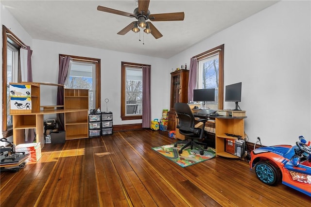 office space with dark wood-type flooring and ceiling fan