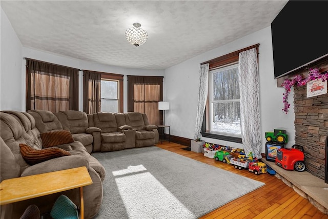 living room with hardwood / wood-style flooring and a textured ceiling