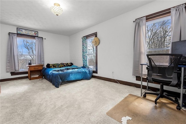 bedroom with multiple windows and carpet