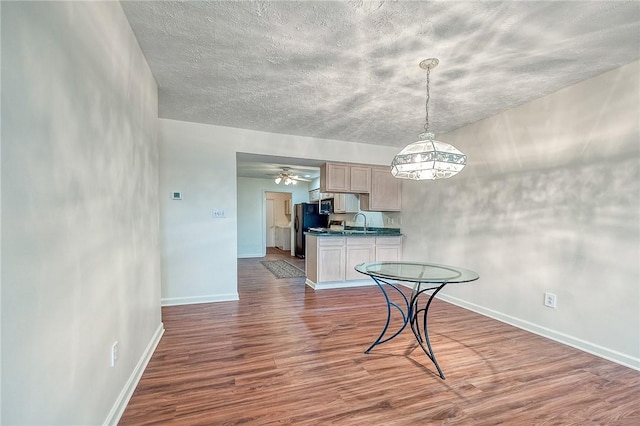 dining room with ceiling fan, sink, and hardwood / wood-style floors