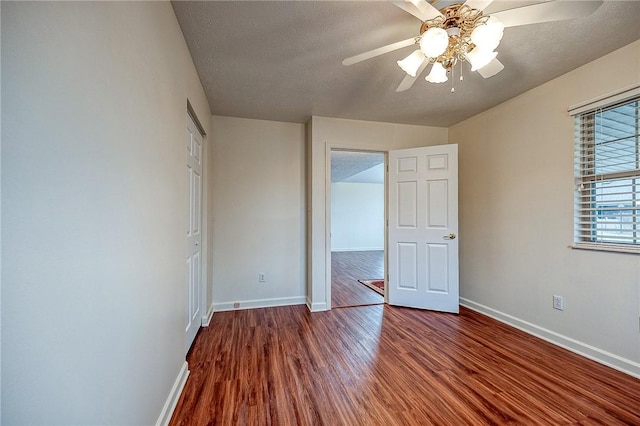 unfurnished bedroom featuring hardwood / wood-style floors, a textured ceiling, and ceiling fan