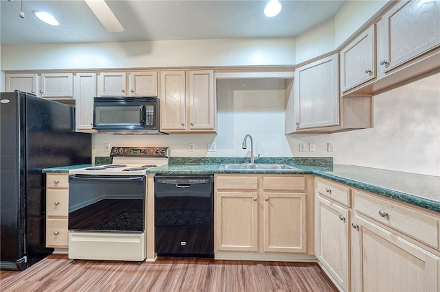 kitchen featuring light brown cabinetry, sink, light wood-type flooring, ceiling fan, and black appliances