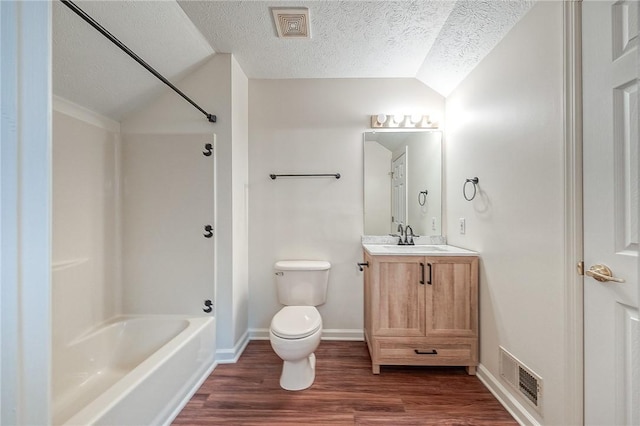 full bathroom with lofted ceiling, hardwood / wood-style flooring, vanity, a textured ceiling, and toilet