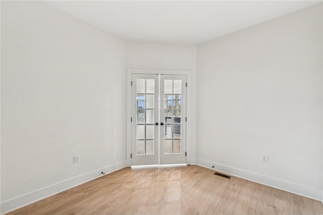 spare room featuring visible vents, french doors, baseboards, and light wood-style floors