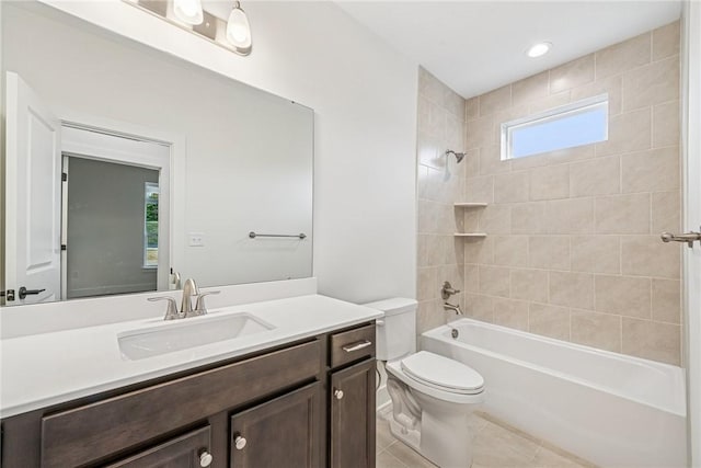 bathroom featuring tile patterned floors, tub / shower combination, toilet, and vanity