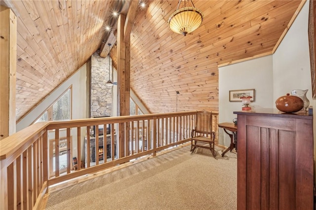 interior space with vaulted ceiling with beams, wood ceiling, and carpet flooring