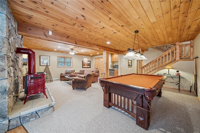 playroom with wooden ceiling, a wood stove, carpet flooring, a baseboard heating unit, and recessed lighting