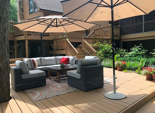 wooden deck featuring stairs and outdoor lounge area