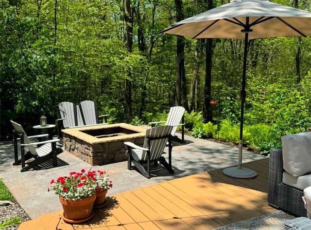 view of patio / terrace featuring a wooden deck and an outdoor fire pit