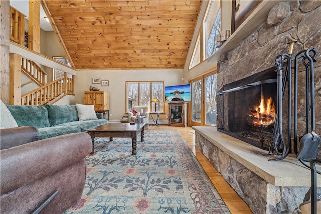 living room with wood ceiling, a fireplace, high vaulted ceiling, and light wood-type flooring