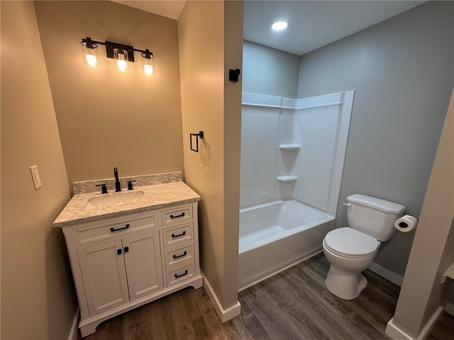 full bathroom with washtub / shower combination, vanity, toilet, and wood-type flooring