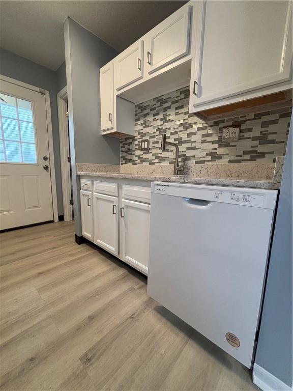 kitchen with white cabinetry, light hardwood / wood-style flooring, and dishwasher