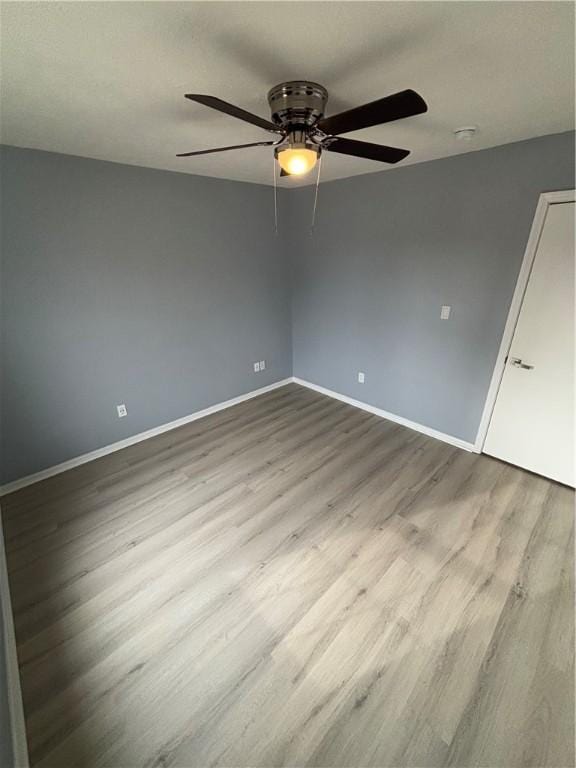 unfurnished room with ceiling fan and light hardwood / wood-style floors