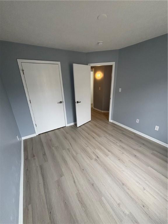 unfurnished bedroom featuring light wood-type flooring