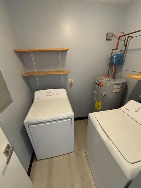 laundry room featuring independent washer and dryer, water heater, and light wood-type flooring