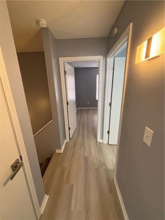 hallway with light hardwood / wood-style flooring