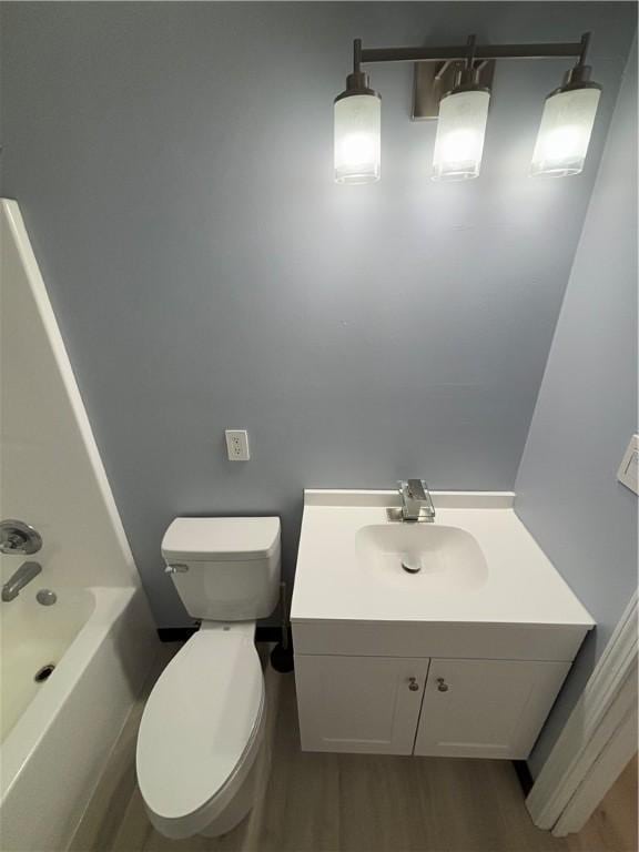 bathroom featuring hardwood / wood-style flooring, vanity, and toilet