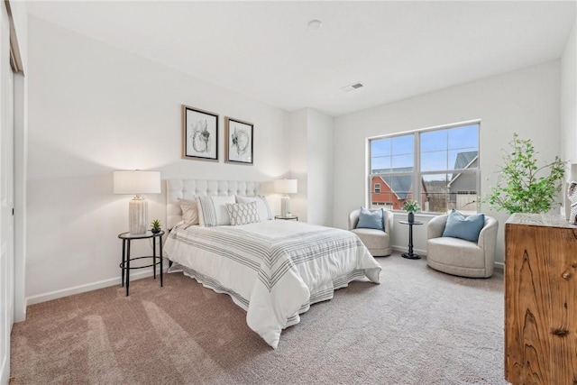 carpeted bedroom featuring visible vents and baseboards