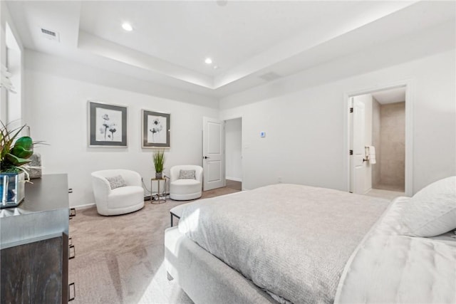 bedroom with recessed lighting, light carpet, visible vents, baseboards, and a tray ceiling