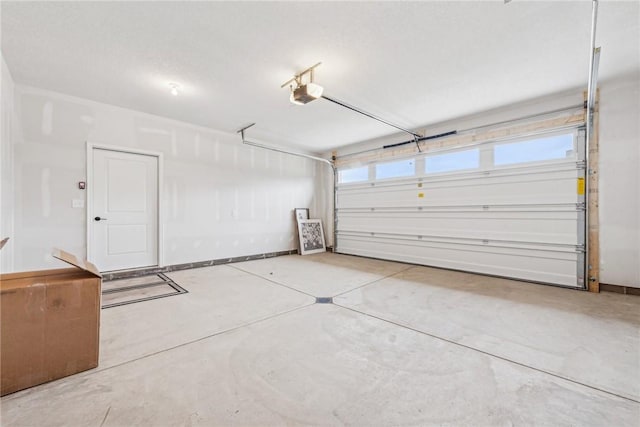 garage featuring baseboards and a garage door opener