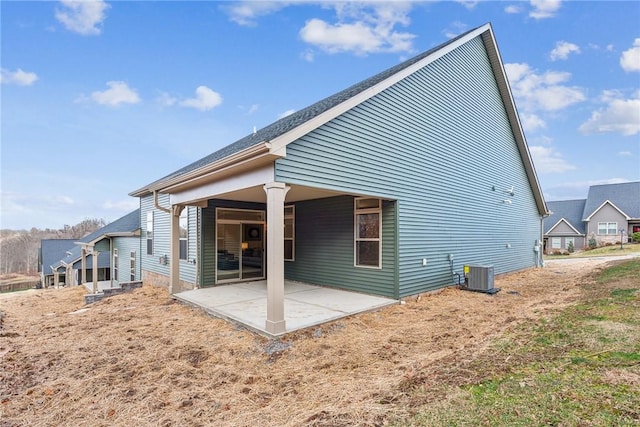 rear view of property featuring a patio area and cooling unit