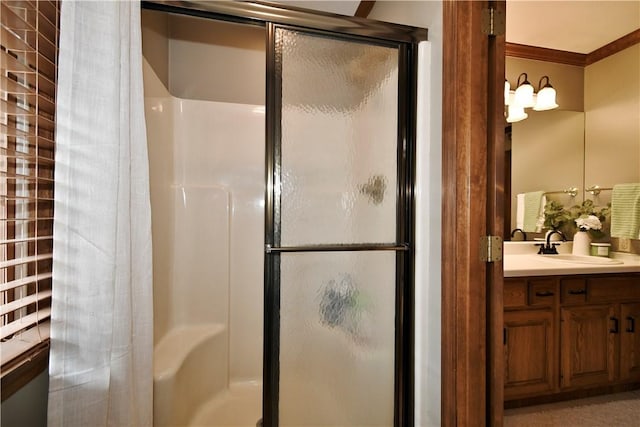 bathroom with crown molding, vanity, and an enclosed shower