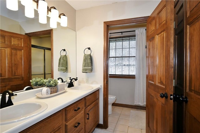 bathroom featuring vanity, curtained shower, tile patterned floors, and toilet