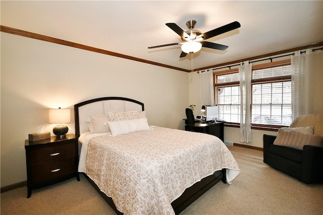 carpeted bedroom featuring crown molding and ceiling fan