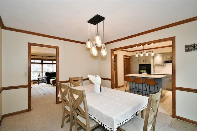 dining area with light carpet and ornamental molding