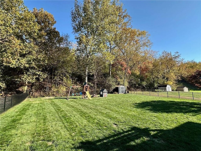 view of yard with a playground and a shed