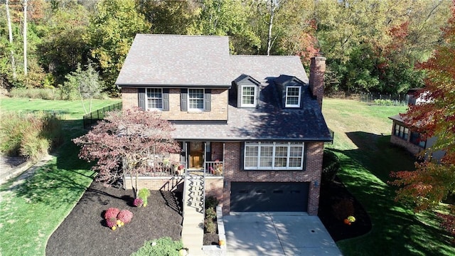 view of front of property with a garage, a front yard, and a porch