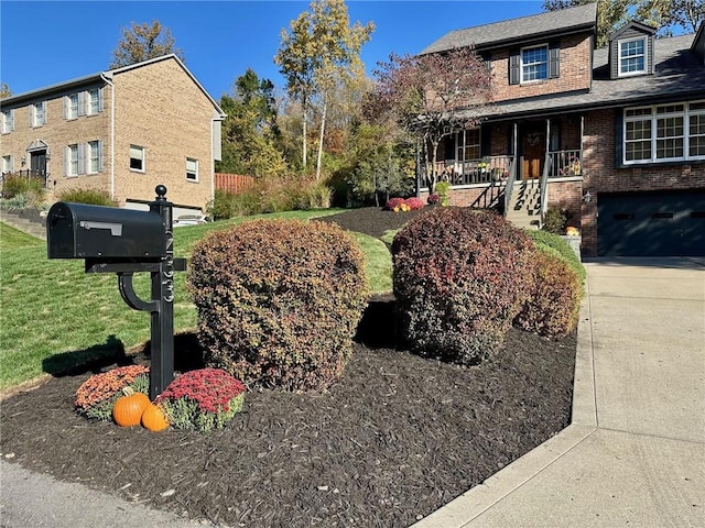 view of side of home with a garage, a lawn, and a porch