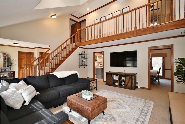 carpeted living room featuring a high ceiling and ornamental molding