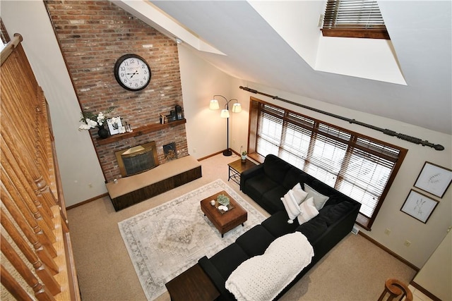 carpeted living room with a fireplace, vaulted ceiling, and plenty of natural light