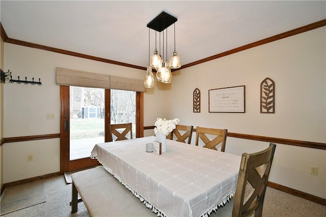 dining area with crown molding and light carpet