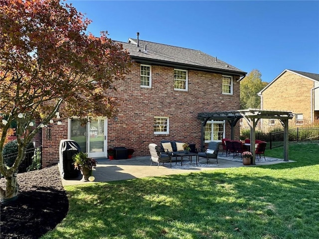 rear view of house with a pergola, a lawn, and a patio area