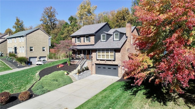 view of front of home with a garage, a front lawn, and a porch