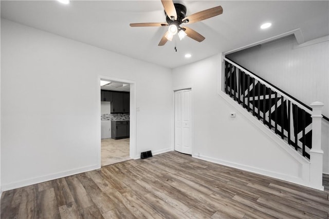 empty room featuring hardwood / wood-style flooring and ceiling fan