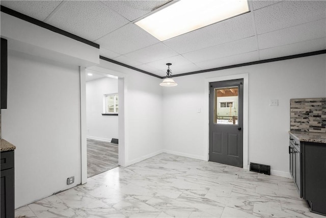 foyer entrance featuring a drop ceiling