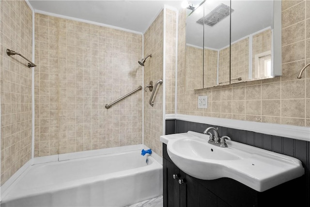 bathroom with vanity and tiled shower / bath combo