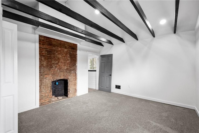 unfurnished living room featuring beamed ceiling, carpet, and a brick fireplace