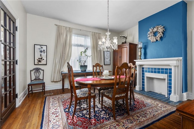 2515 Middle Rd, Hampton, PA 15116 - dining area featuring a chandelier, baseboards, wood finished floors, and a tile fireplace