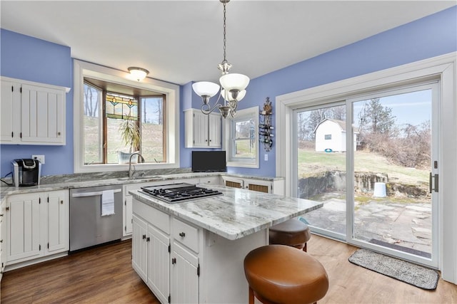 2515 Middle Rd, Hampton, PA 15116 - kitchen with stainless steel appliances, a sink, white cabinets, a chandelier, and wood finished floors