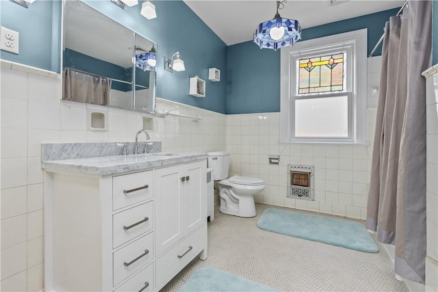 2515 Middle Rd, Hampton, PA 15116 - bathroom with heating unit, tile walls, toilet, vanity, and a wainscoted wall