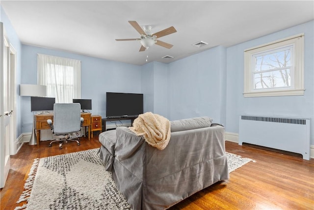 2515 Middle Rd, Hampton, PA 15116 - bedroom with radiator heating unit, multiple windows, and wood finished floors